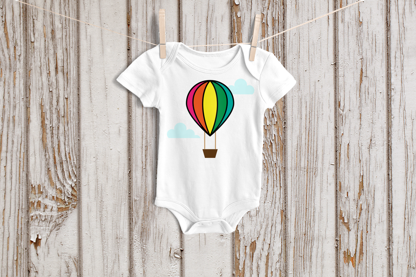 Hot air balloon with clouds design on a baby onesie.