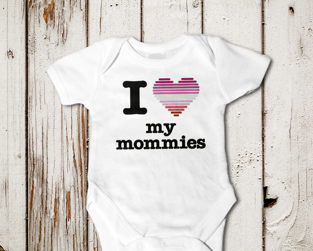 Baby onesie that says "I heart my mommies." The heart is made out of stripes in pride flag colors.