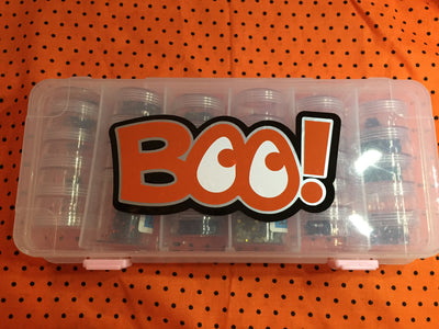 A plastic case with the word "BOO!" in black, white, silver, and orange. The Os look like eyes.