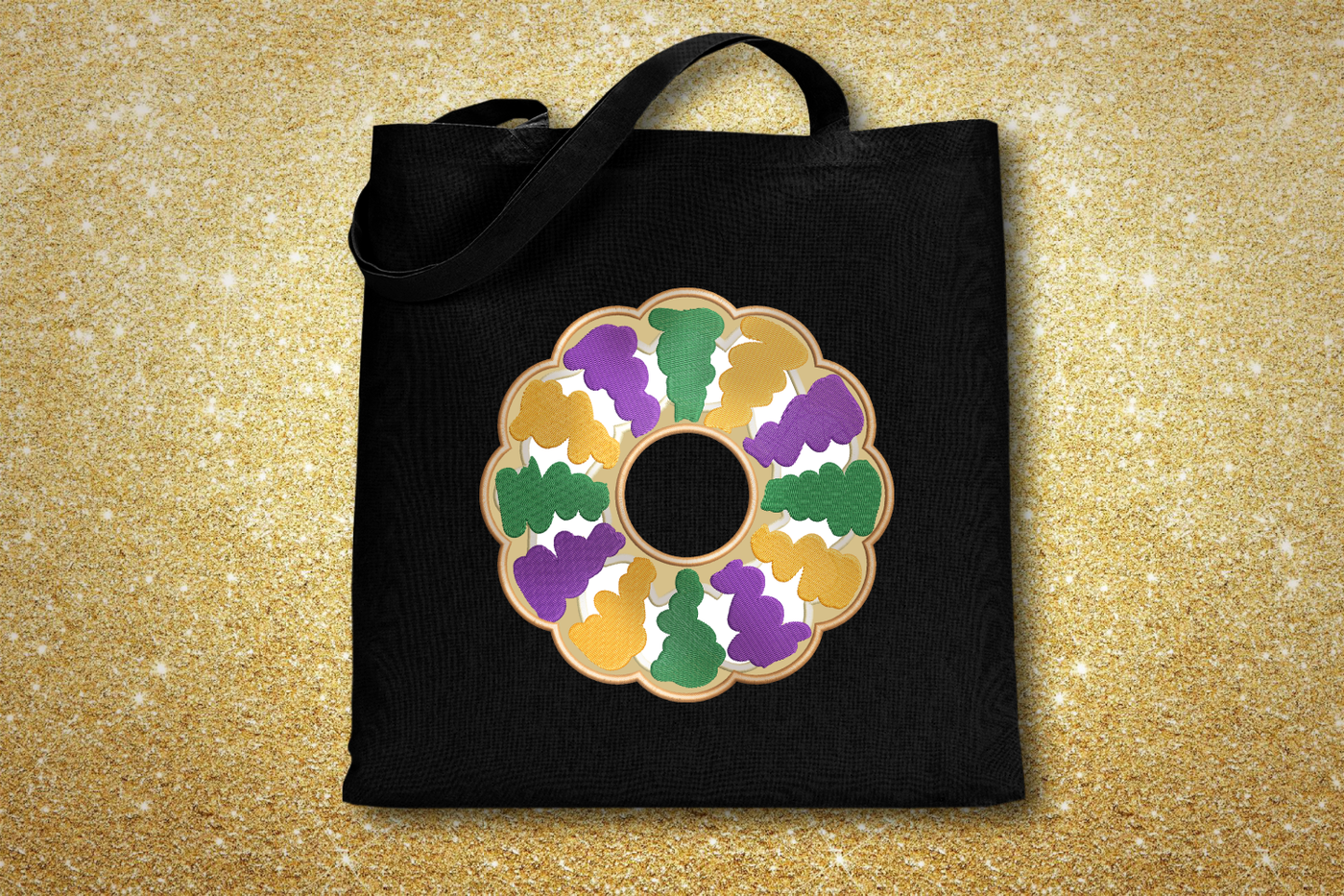 Black tote bag with an applique King Cake design