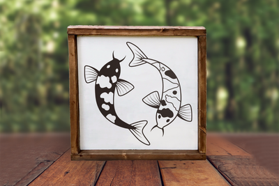 Square framed sign with 2 swimming koi fish.