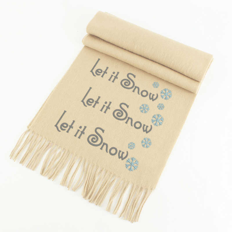 Embroidered trio of the phrase "Let it Snow" with snowflakes along the side.