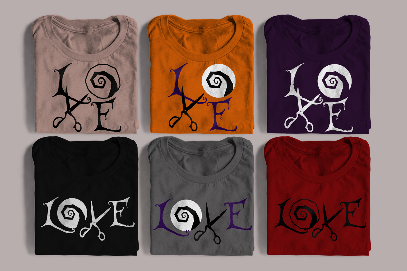 Six folded tees. Each has a design of the word "LOVE." Half have the word set square. The letters are in gothic style. In place of the O is a circle with a rough swirl. In place of the V are a pair of old scissors.