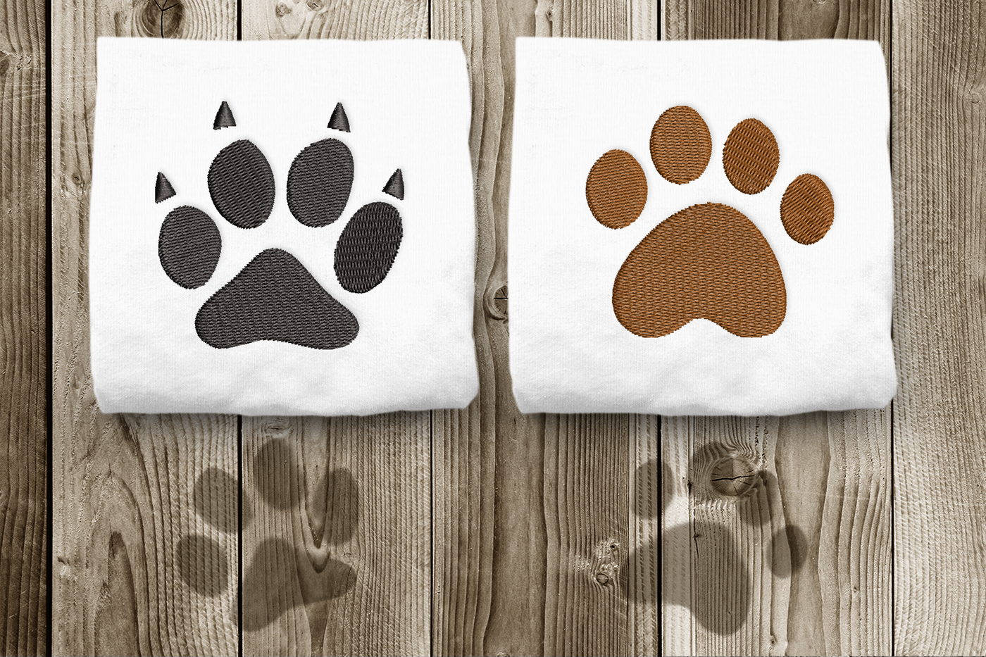 Cat and dog paw print embroidery design duo. Each is shown stitched onto a folded white square of fabric.