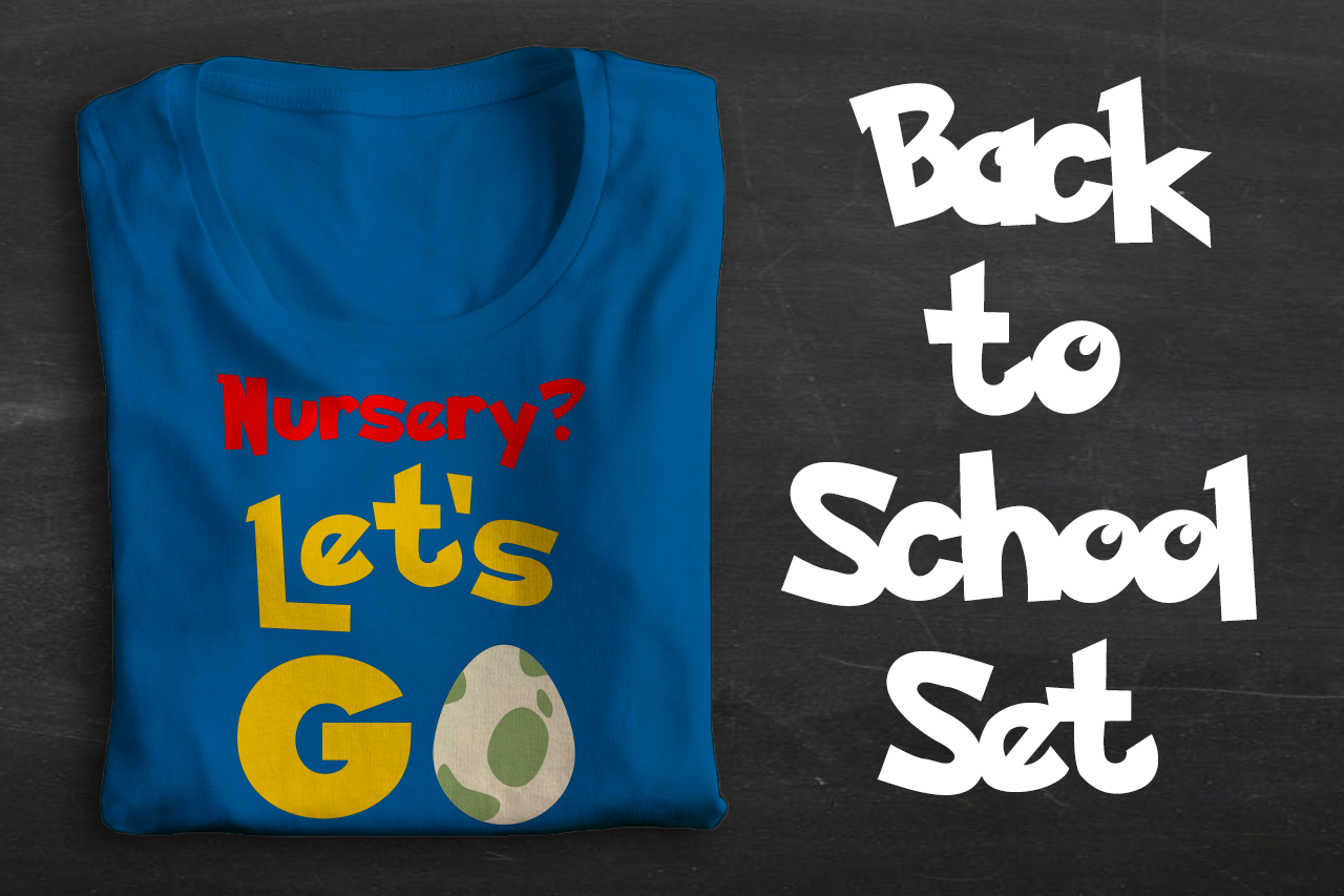 A blue folded tee sits on a chalkboard backdrop. The shirt says "Nursery? Let's GO" with a spotted cream and green egg in place of the O. To the right it says "Back to School Set."