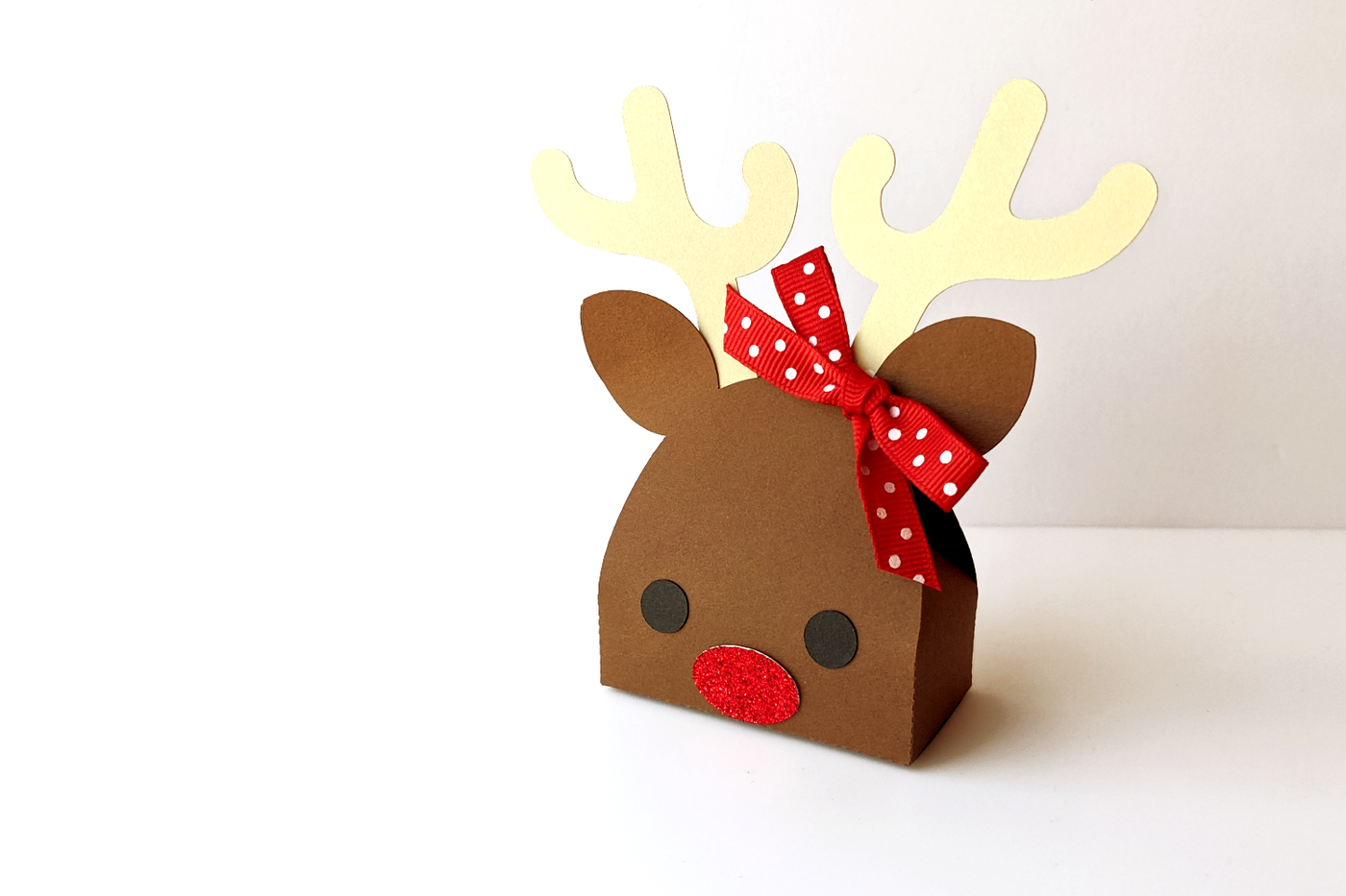 Christmas gift box in the shape of a reindeer face with antlers.
