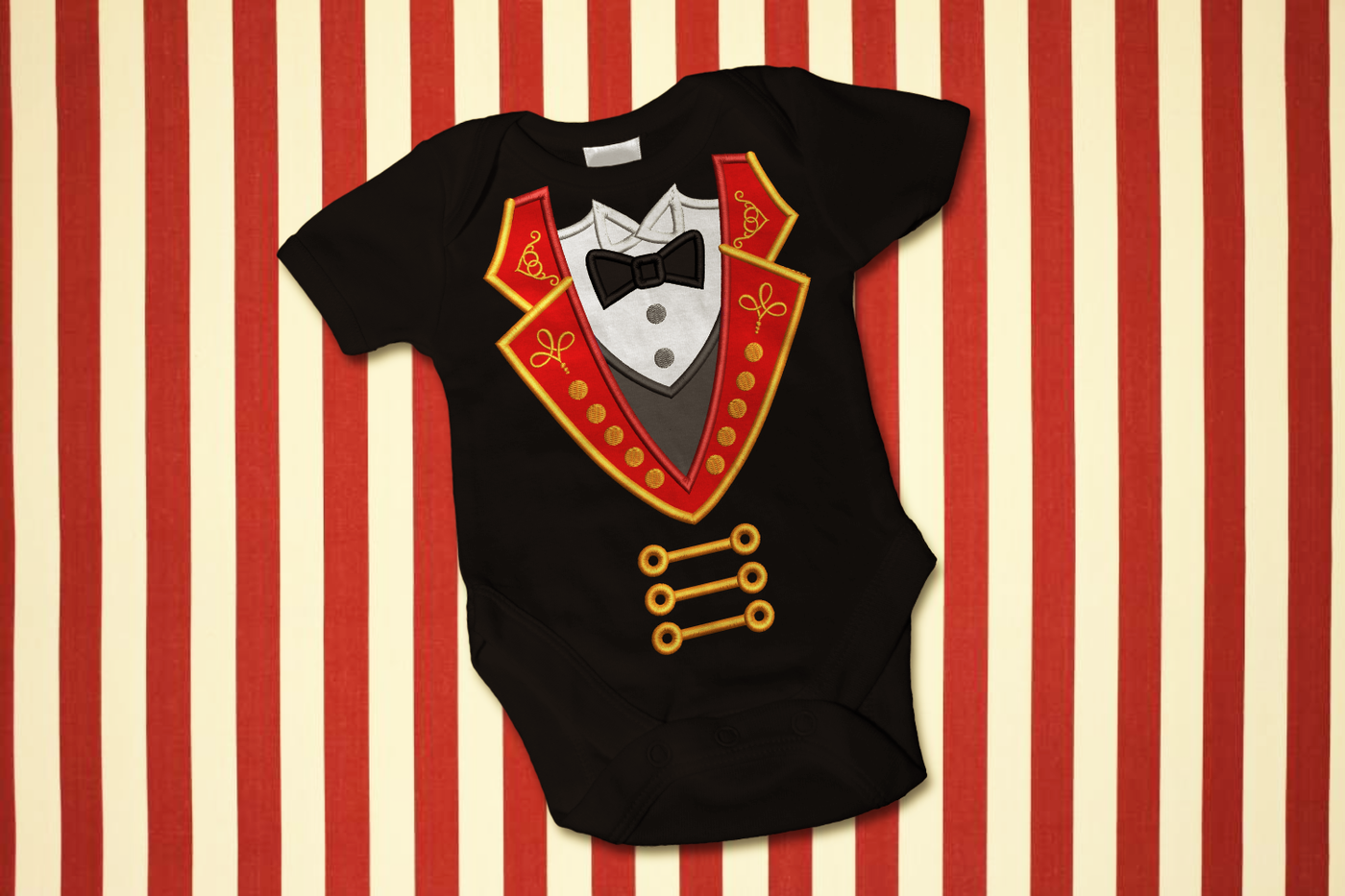 A black onesie on a red and ivory striped background. Appliqued onto the onesie is a design to make it look like a ringmaster's coat.