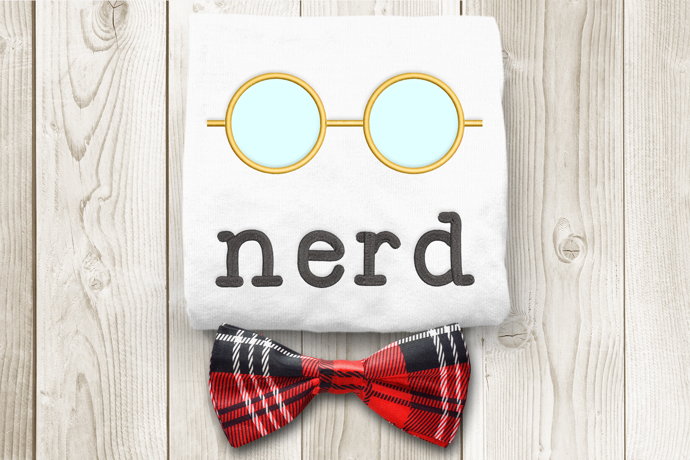 Embroidery design of round glasses with the word "nerd" below. Shown with applique fabric in the lenses.