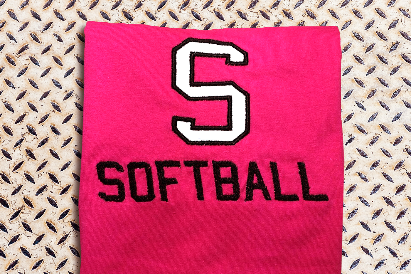 Applique S with the embroidered word "Softball" below