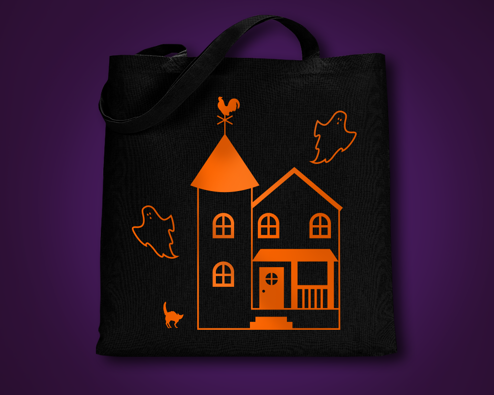 Haunted house done as a single color design on a black tote bag.