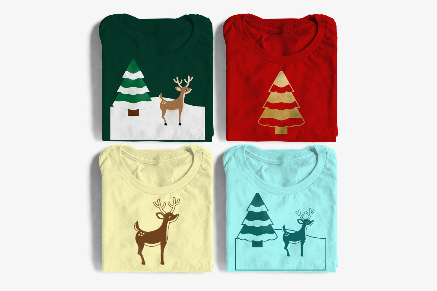 For folded tees. The top left and bottom right have a deer standing in snow with a snow capped tree. One is full color, the other has a single color version of the design. The top right has a snow capped tree. The bottom left has a deer..