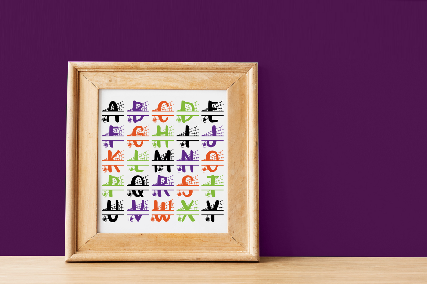 Alphabet split set. The letters have a spiderweb and crawling spider.