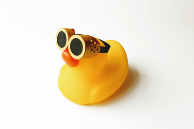 A pair of steampunk goggles made out of paper on a rubber duck