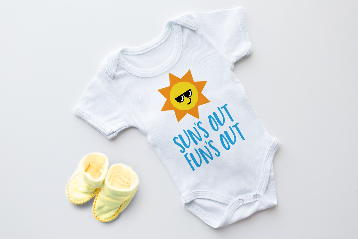 Sun's Out Fun's Out SVG design with a kawaii sun wearing sunglasses. Shown on a baby onesie.