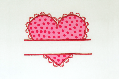 Applique heart with a split and a lacy border.