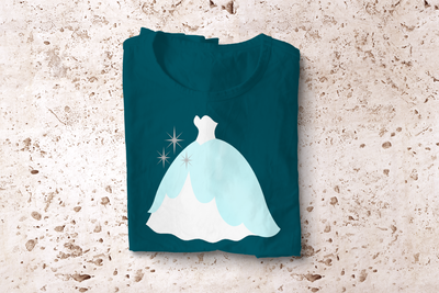 A folded tee with the design of a fancy gown shown slightly from the side with sparkles.