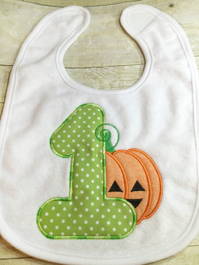 Bib with a large applique 1 and a cute Jack-o-lantern.