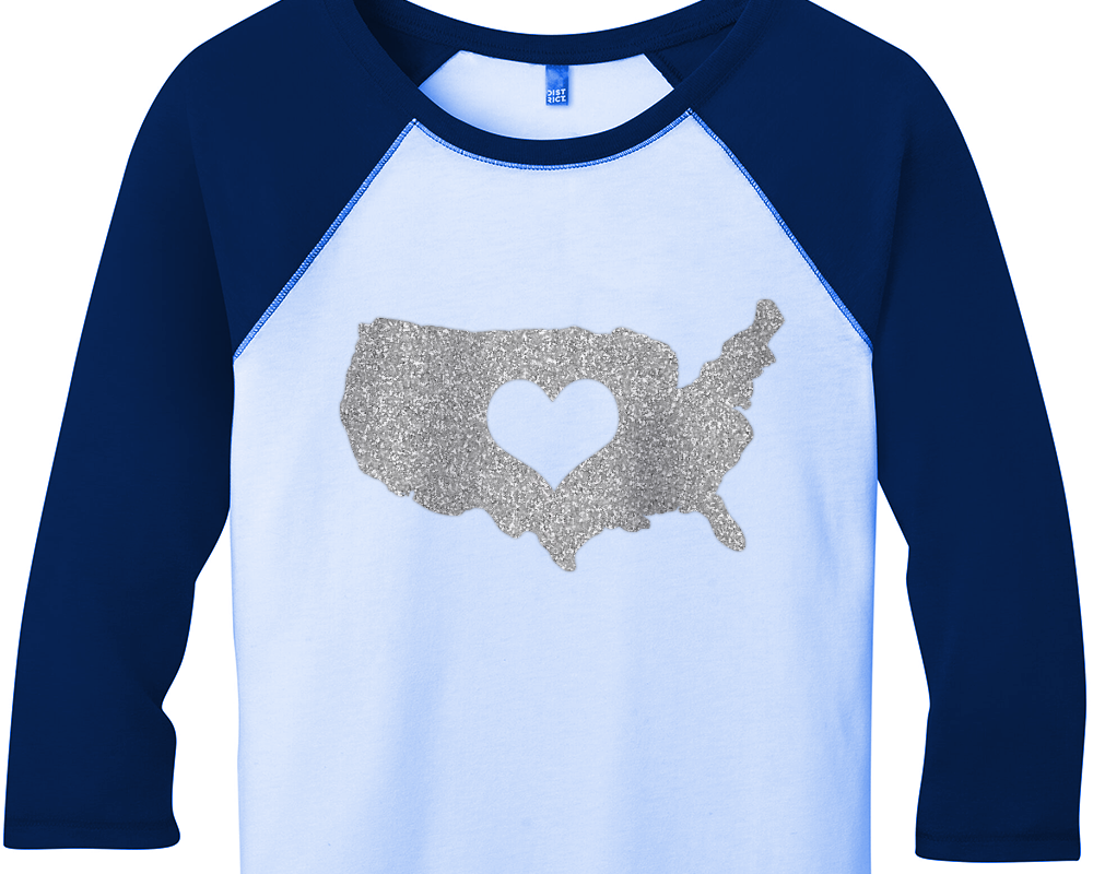 Raglan shirt with an image of the United States with a heart knocked out of the middle.