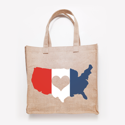 Tote bag with in image of the United States. It is made from 3 colors in horizontal bands and there is a heart knocked out of the middle.