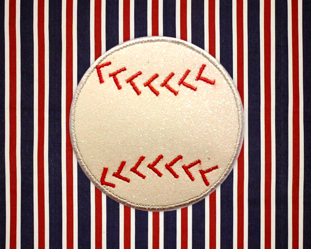 An applique baseball with red stitching has been sewn to striped red, white, and blue fabric.