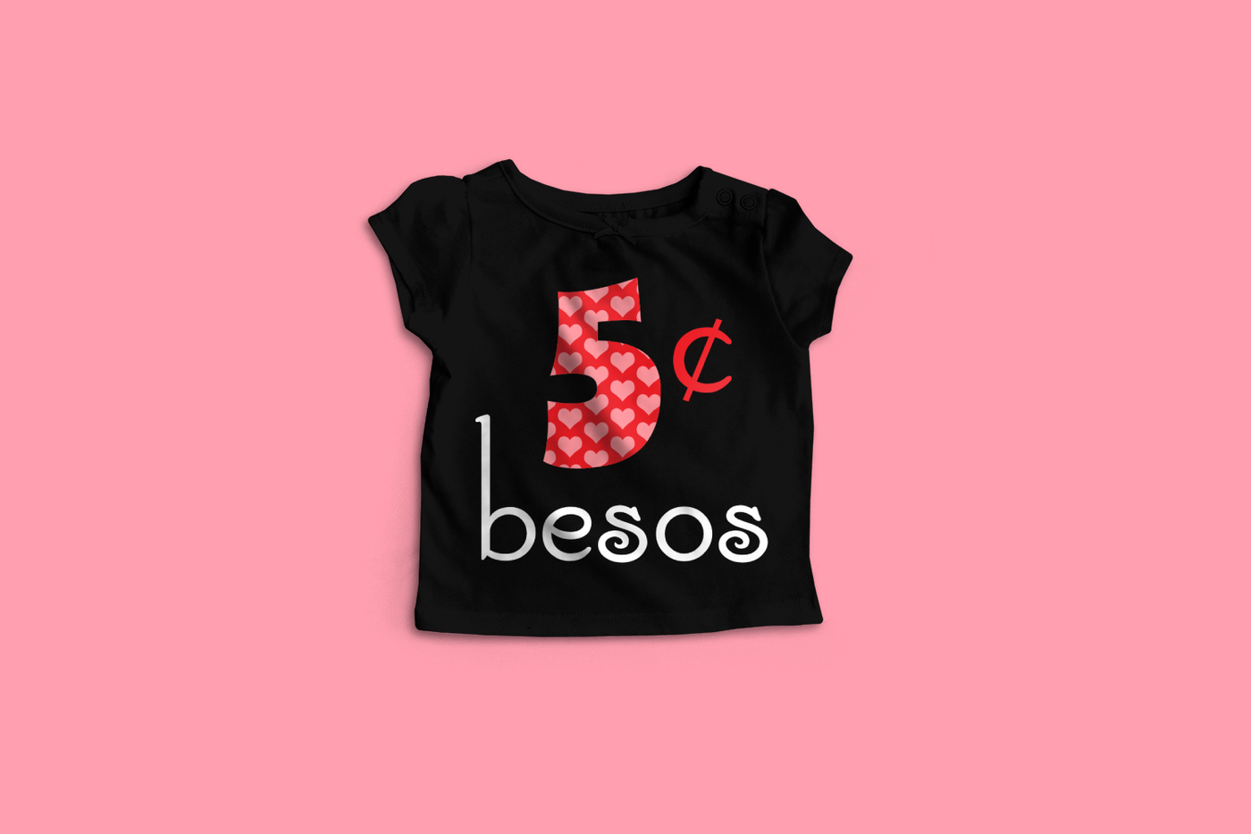 A black child's shirt on a pink backdrop. The shirt has a large 5 with a heart pattern and the cent symbol next to it and word "besos" below.