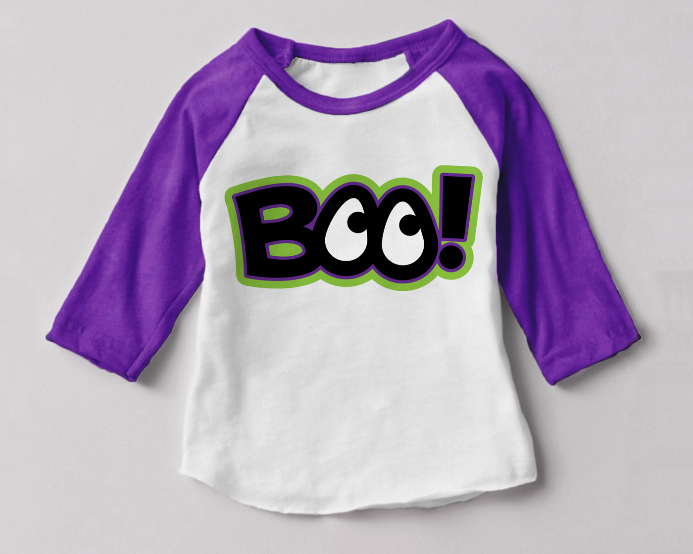 A purple and white raglan with the word "BOO!" in black, white, green, and purple. The Os look like eyes.