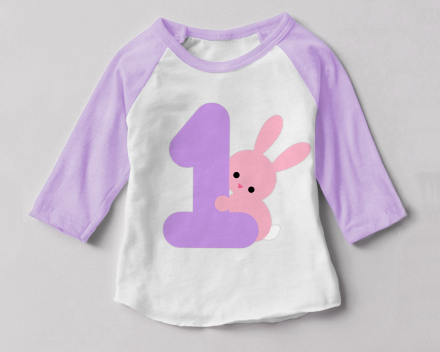 Baby raglan tee with a large 1 on it. Behind the number is a cute bunny.