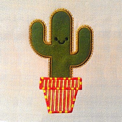 A green cactus in a pot is embroidered onto a piece of natural canvas fabric. The applique fabric for the pot is striped. Around the applique of the cactus are embroidered spines.