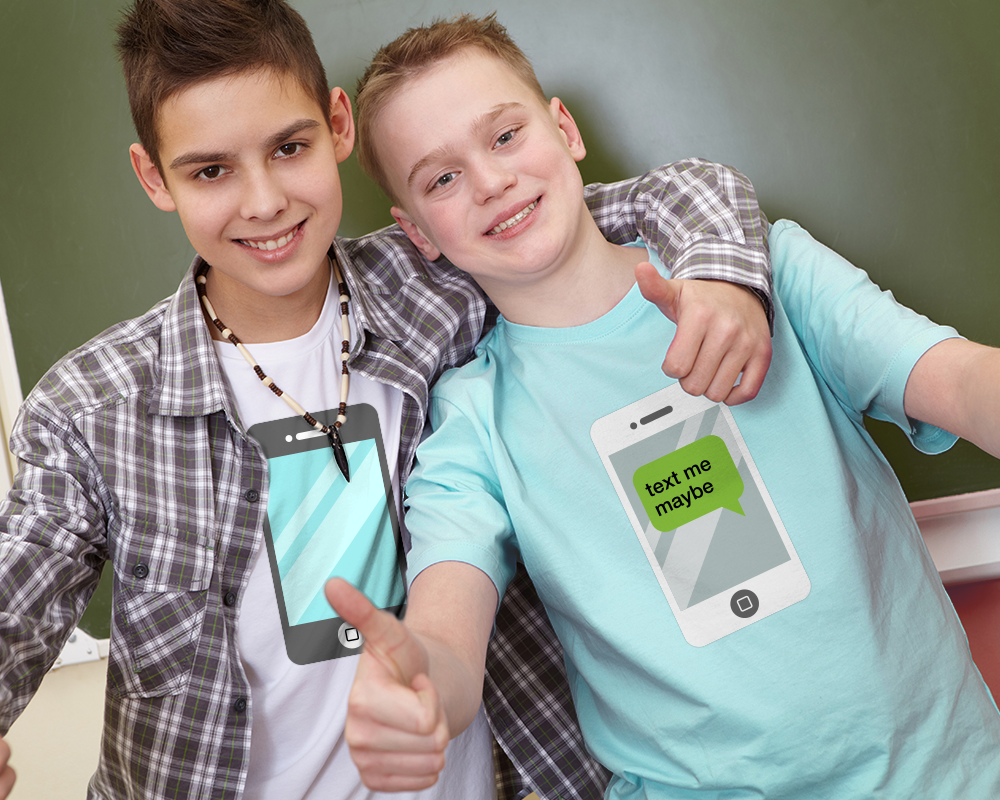 Two white tween boys give a thumbs up. One boy has his arm around his the other boy's shoulder. Both boys are wearing shirts with an image of a smart phone. One boy has a text bubble on the phone that says "text me maybe."