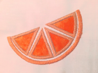 Peach fabric with an applique grapefruit slice.