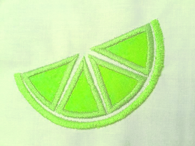 Pale green fabric with a green applique citrus slice.