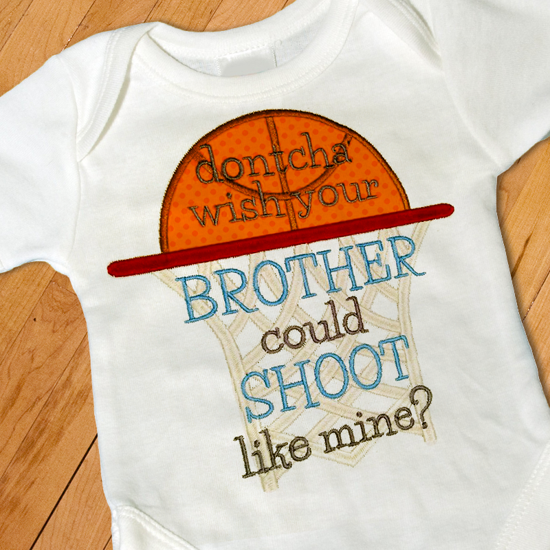 A white baby onesie with an applique basketball and hoop. Embroidered on top is the phrase "dontcha wish your BROTHER could SHOOT like mine?"