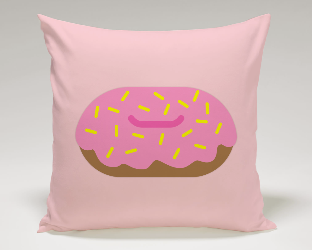 A pink throw pillow with a pink-frosted donut design with yellow sprinkles.