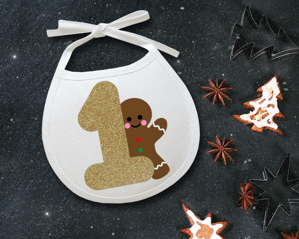 Bib with a design that has a large number 1 and a gingerbread man peeking out behind it.