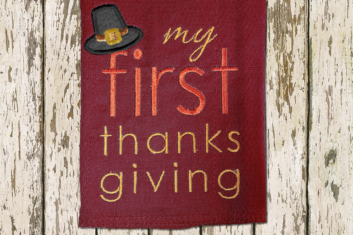 "My first thanksgiving" applique design with a pilgrim hat on the F.