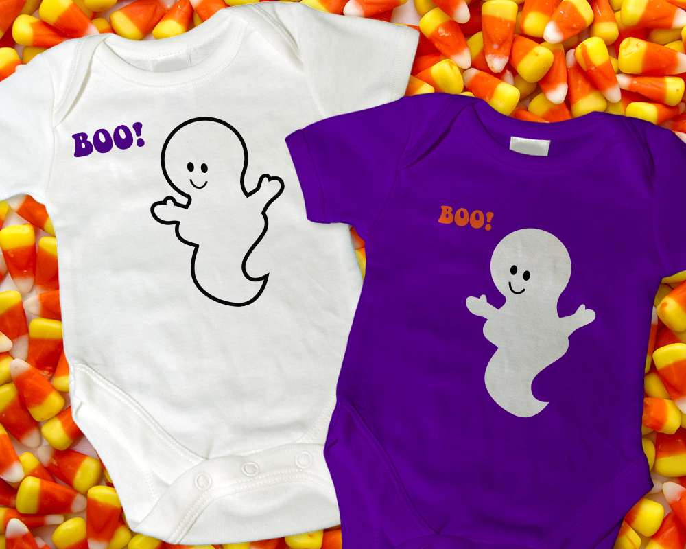 Two onesies on a background of candy corn. Each has a friendly ghost saying "Boo!"