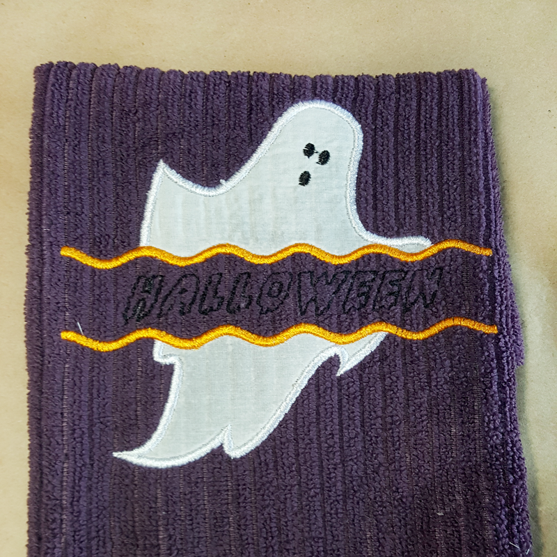 Ghost applique with wavy line split. Text has been added to the split space.