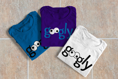 Three folded tees. Each has the word "googly" with googly eyes for the Os.