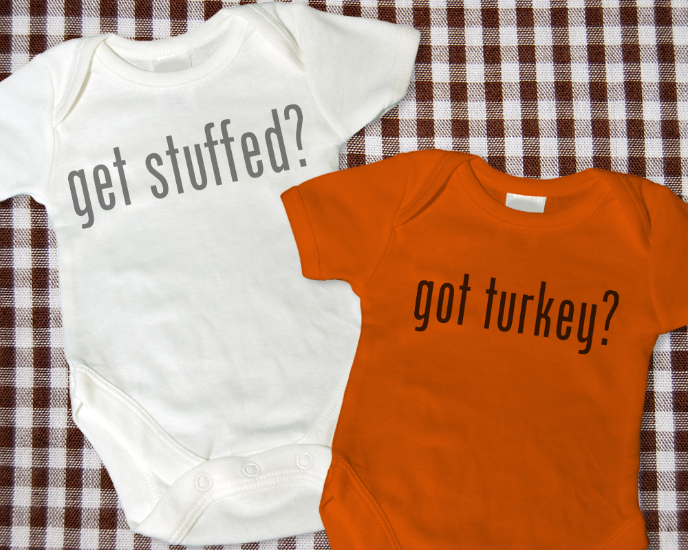 Two baby onesies. One says "get stuffed?" the other says "got turkey?"