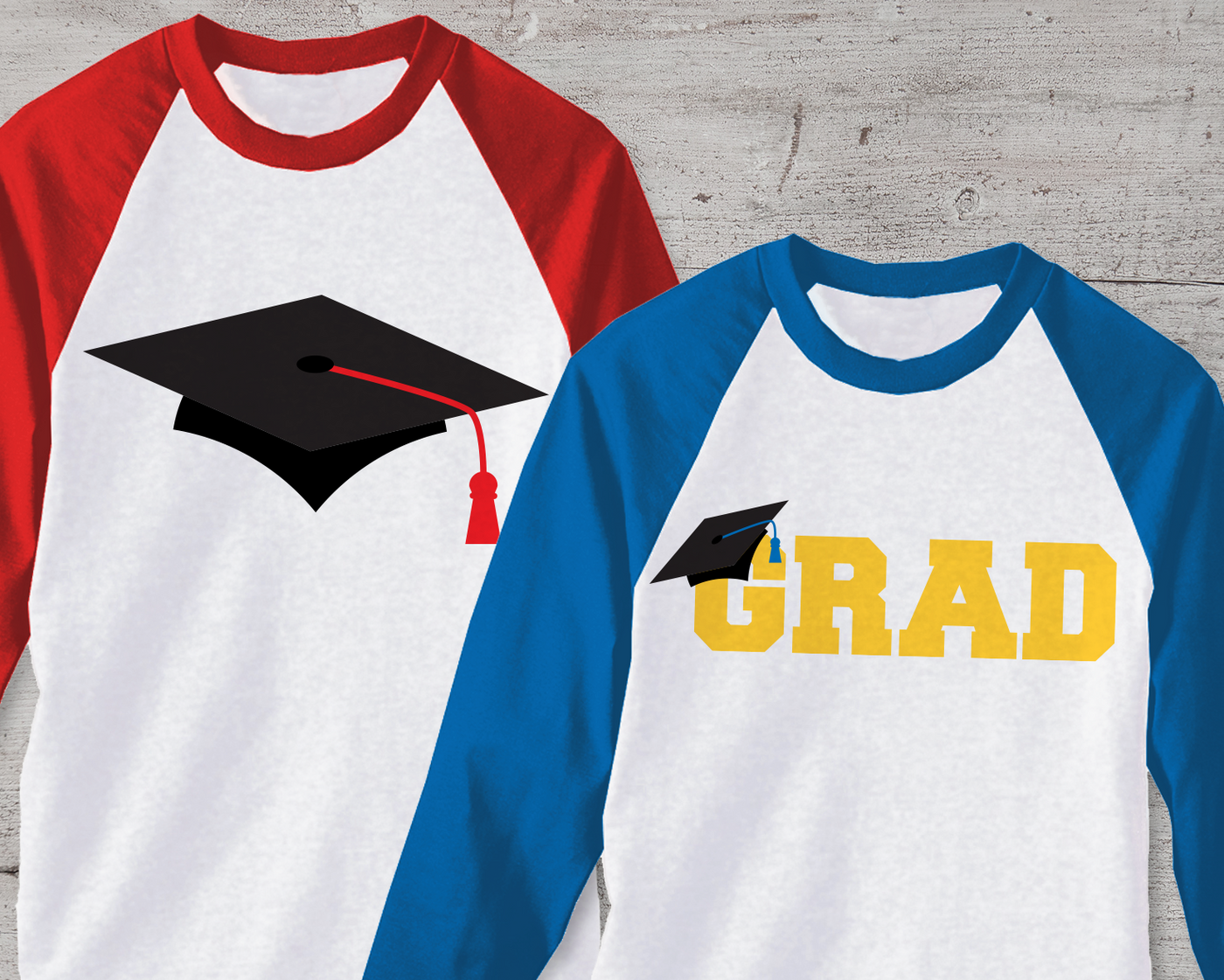 Two raglan tees. One has a graduation cap design, the other says "GRAD" and has a cap hanging off of the G.