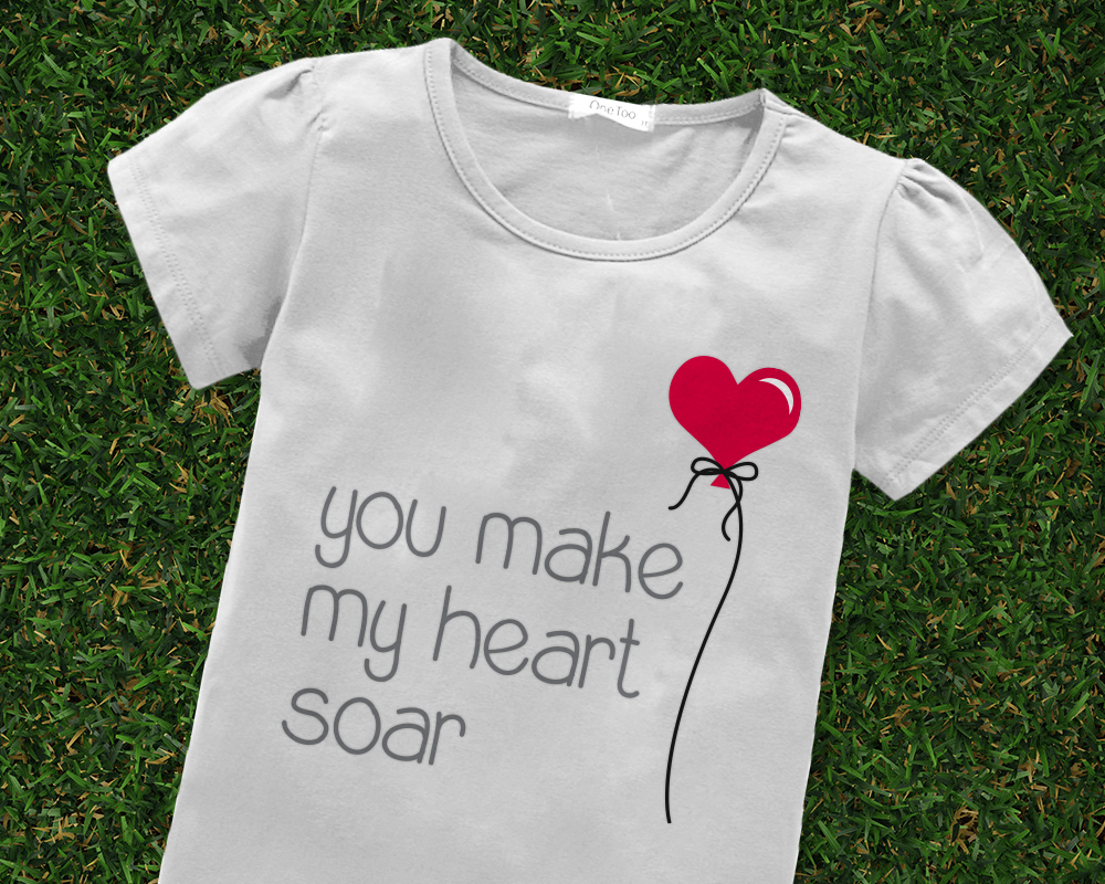 Tee with a heart shaped balloon design and the words "you make my heart soar"