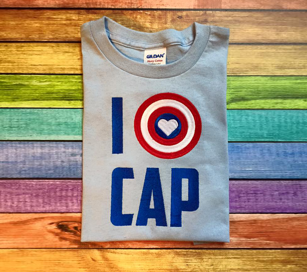 Embroidered shirt that says "I heart cap." The heart sits inside of a target design.