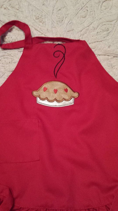 Applique of a cooling pie with heart cut outs in the crust.