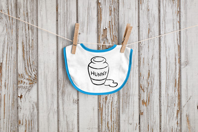 Baby bib with a pot that says "HUNNY" and some spilled honey.