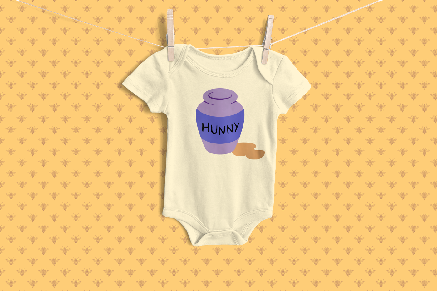 Baby onesie with a pot that says "HUNNY" and some spilled honey.