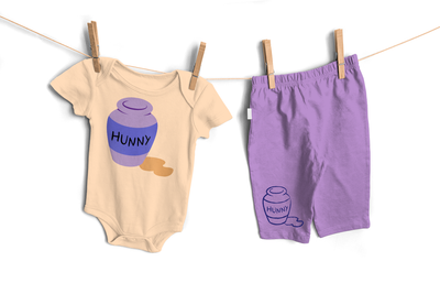 Baby onesie and baby pants, each with a pot that says "HUNNY" and some spilled honey.