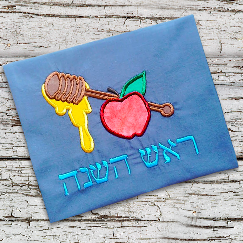 Apple and honey applique design with the words "rosh hashanah" in Hebrew