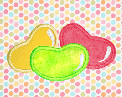 3 applique jelly beans in yellow, green, and pink, on a background of multicolored polkadot fabric in similar tones.