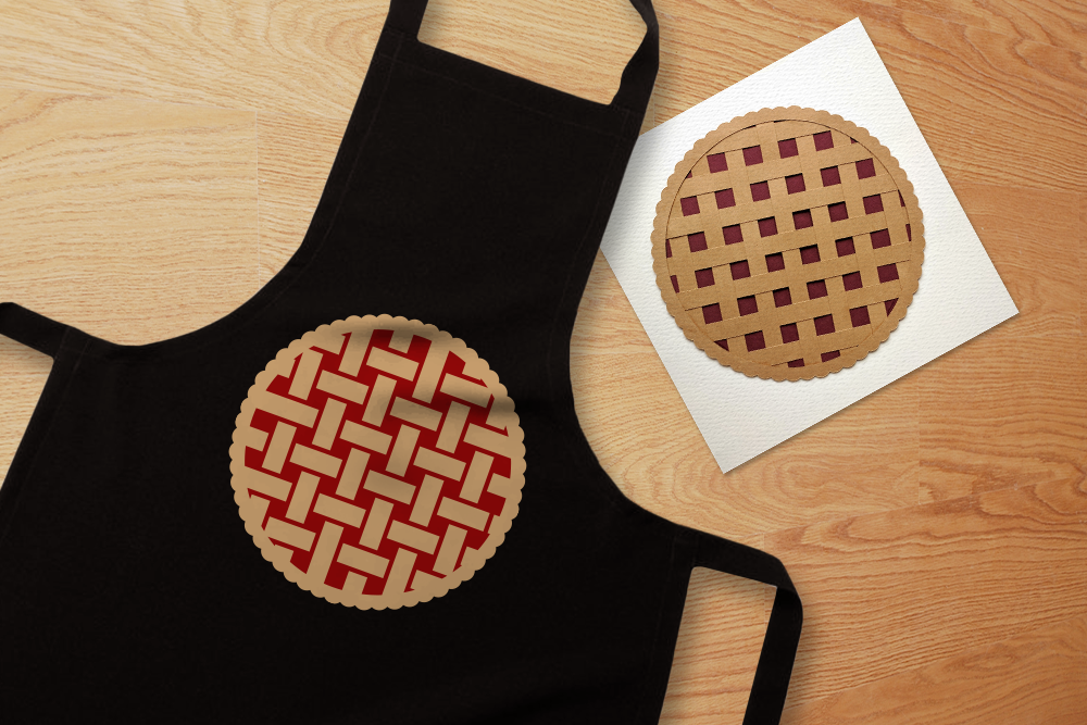 Apron with a lattice pie design. Next to it is a card with a paper pie with a lattice crust.