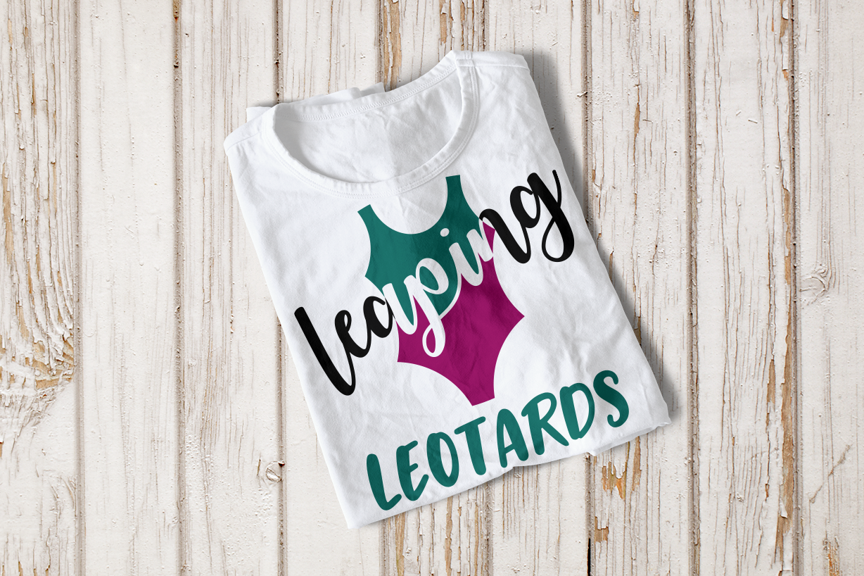 Folded tee with a gymnastic leotard in 2 colors and the text "leaping leotards"